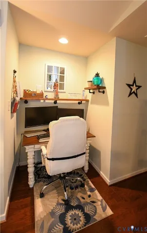 a living room with a rug and a wooden floor