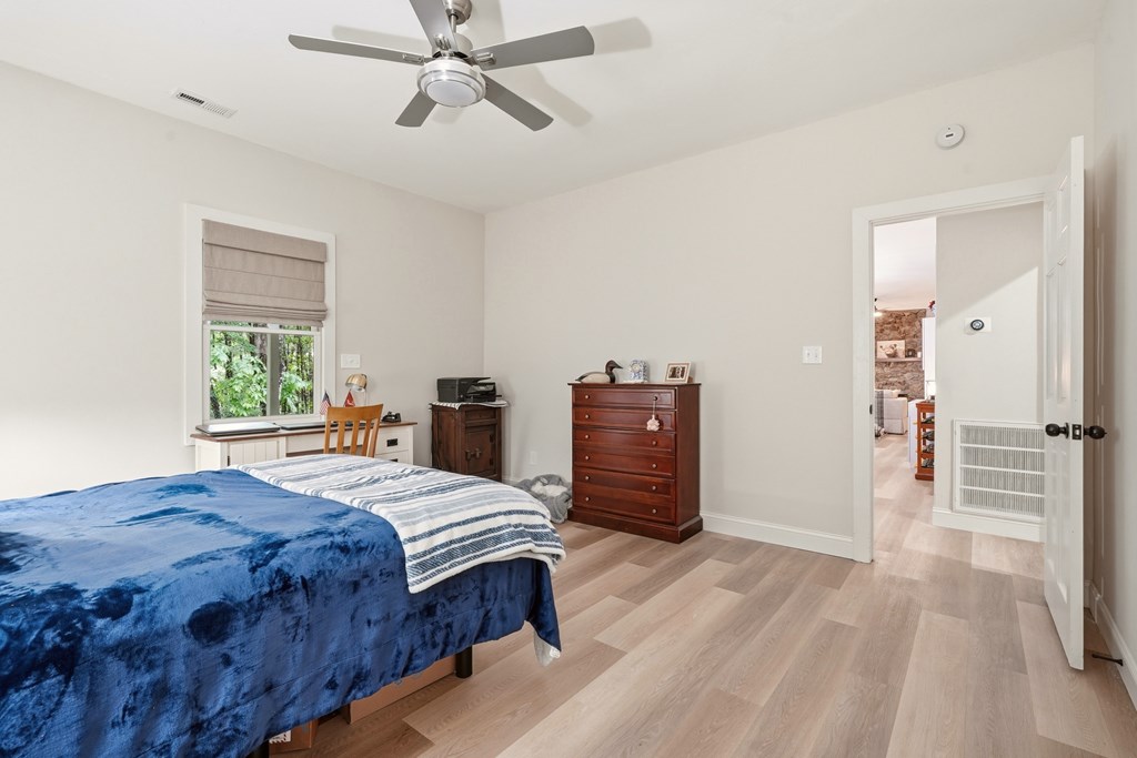 175 Crane Creek Road Young Harris, GA 30582 - Photo 20 of 40 a bedroom with a bed and a chandelier