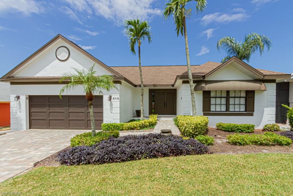 410 Panay Avenue Naples, FL 34113 - Photo 2 of 34 a front view of a house with garden