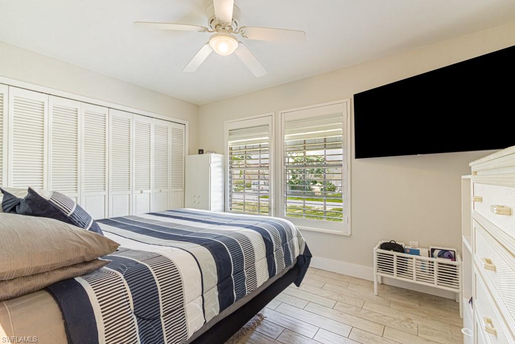 410 Panay Avenue Naples, FL 34113 - Photo 22 of 34 a bedroom with a large bed and a flat tv screen on dresser