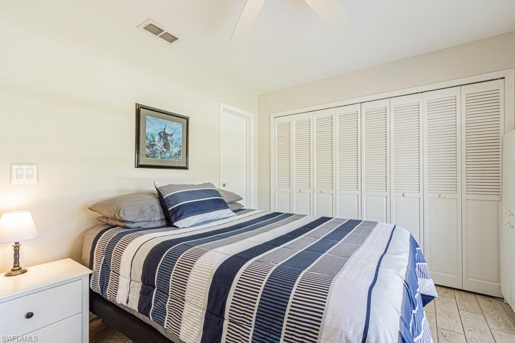 410 Panay Avenue Naples, FL 34113 - Photo 23 of 34 a bedroom with a bed and a painting on the wall