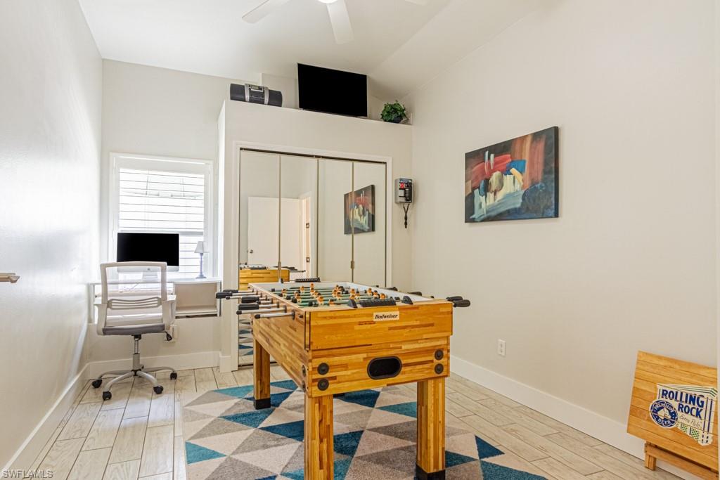 410 Panay Avenue Naples, FL 34113 - Photo 24 of 34 a work room with furniture and a wooden floor