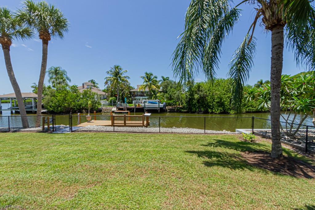 410 Panay Avenue Naples, FL 34113 - Photo 30 of 34 a swimming pool with outdoor seating and yard