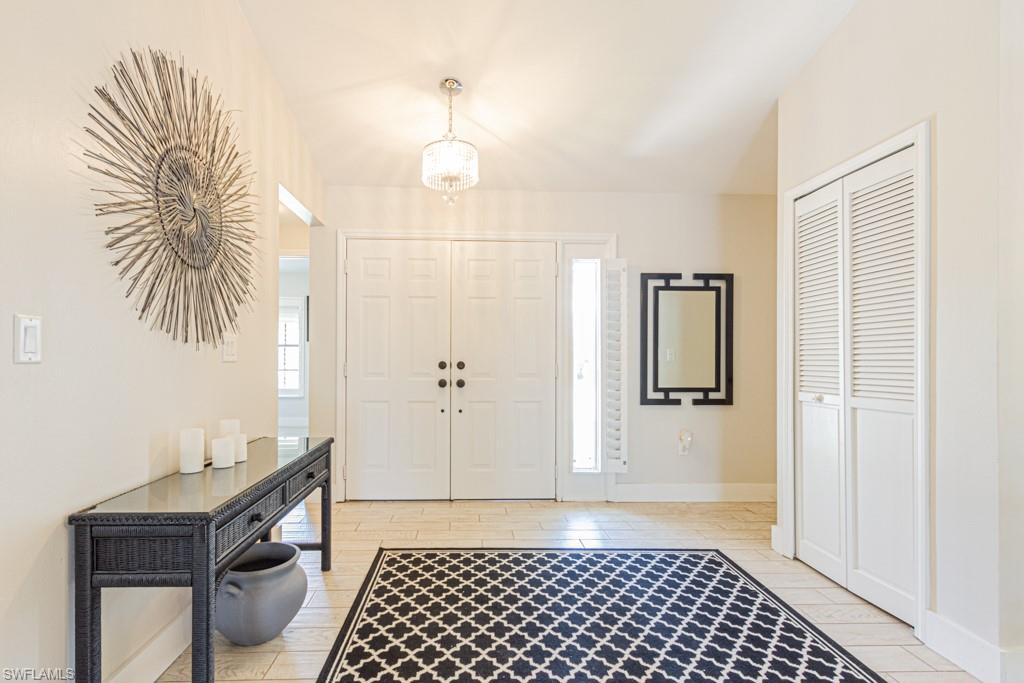410 Panay Avenue Naples, FL 34113 - Photo 3 of 34 a bathroom with a sink and a mirror