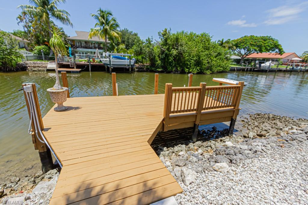 410 Panay Avenue Naples, FL 34113 - Photo 33 of 34 a view of a lake with a deck
