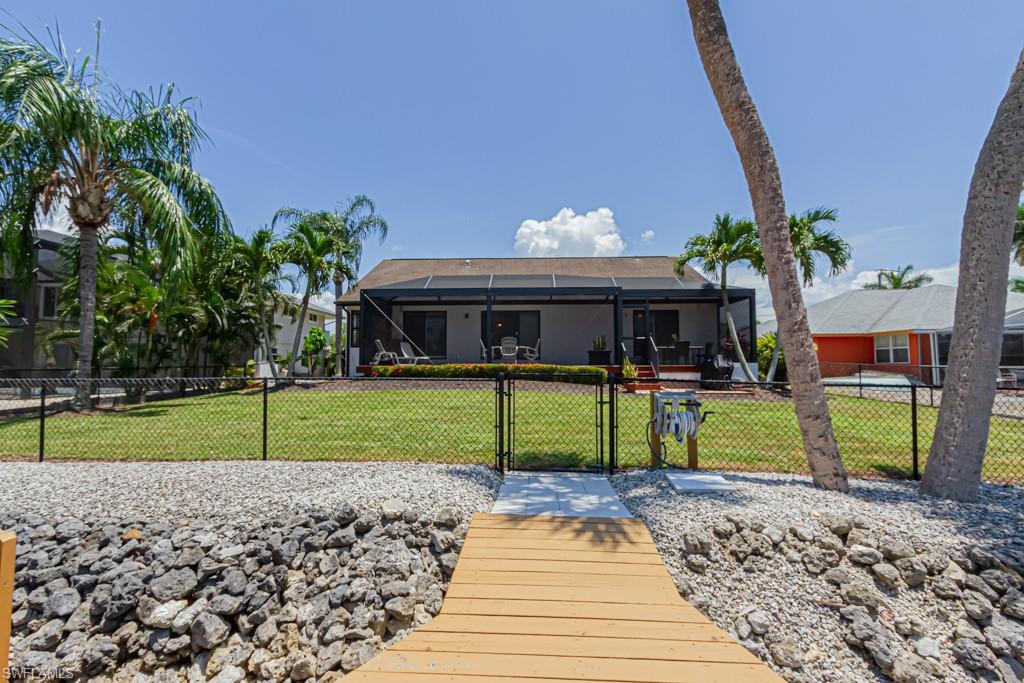 410 Panay Avenue Naples, FL 34113 - Photo 34 of 34 a view of house with outdoor space and entertaining space