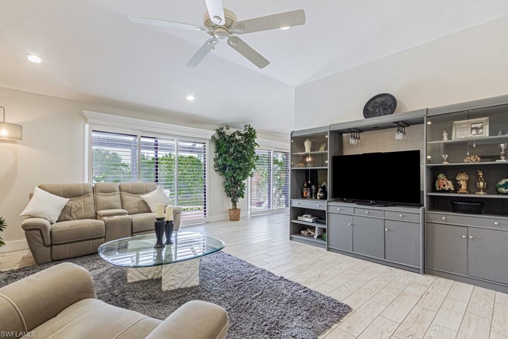410 Panay Avenue Naples, FL 34113 - Photo 5 of 34 a living room with furniture and a flat screen tv