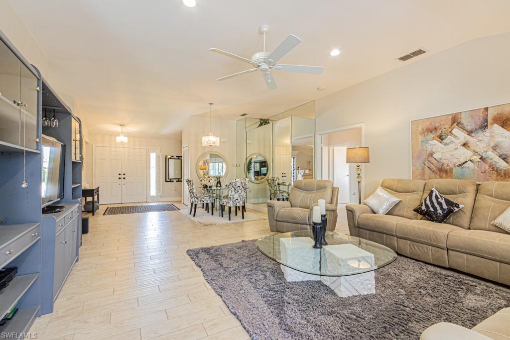 410 Panay Avenue Naples, FL 34113 - Photo 8 of 34 a living room with furniture and a chandelier