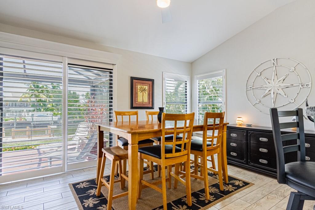 410 Panay Avenue Naples, FL 34113 - Photo 10 of 34 a view of a dining room with furniture window and wooden floor
