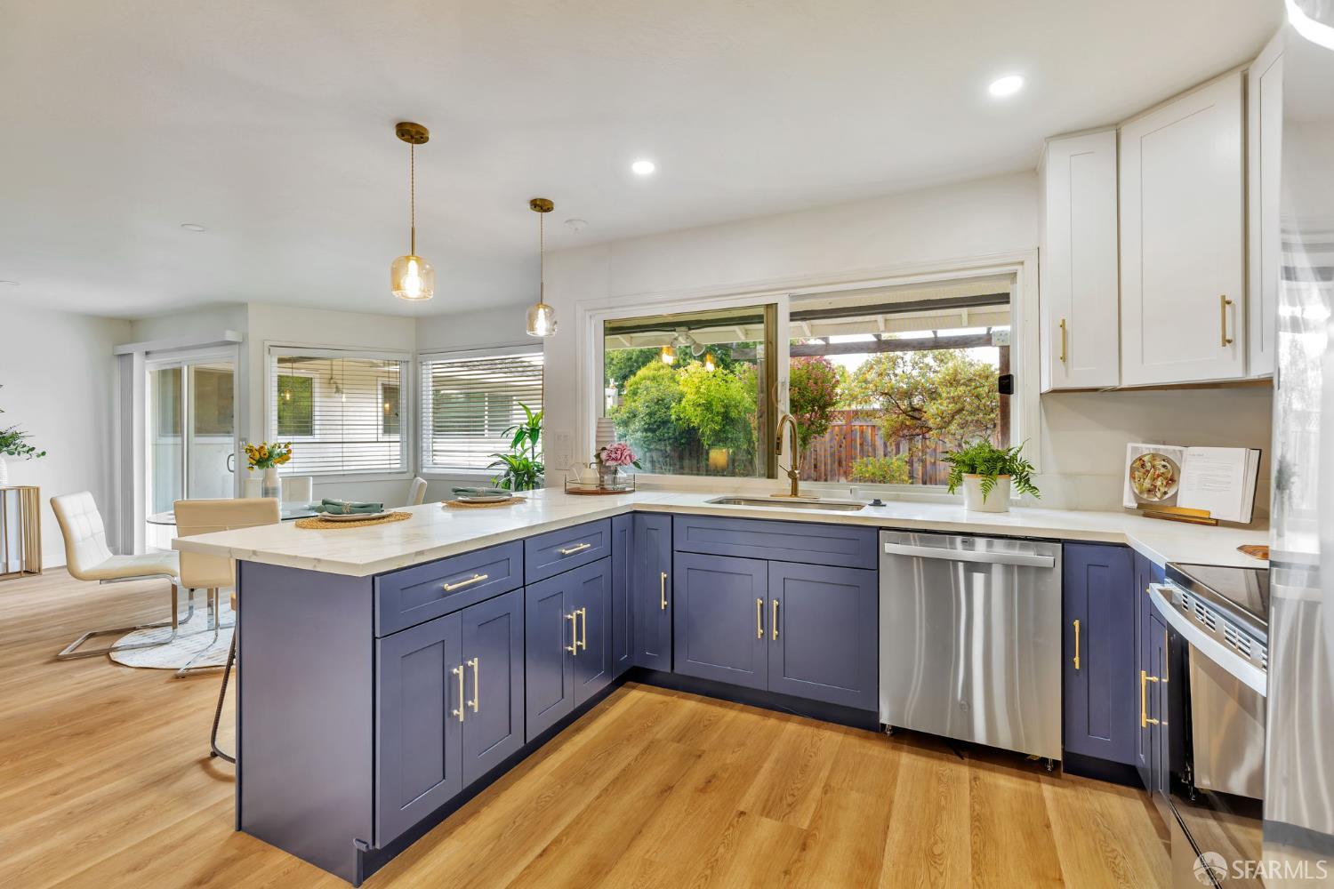 1467 Hudson Way Livermore, CA 94550 - Photo 12 of 48 a large kitchen with wooden floors and stainless steel appliances