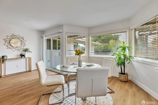 a view of a dining room with furniture window and wooden floor