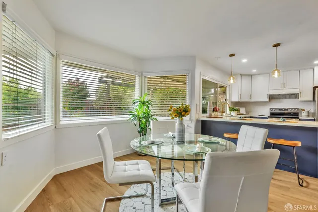a dining room with furniture a window and kitchen view