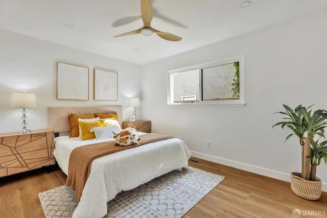 a bedroom with bed and a potted plant