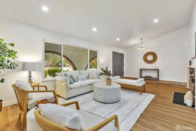 a living room with furniture and a large window