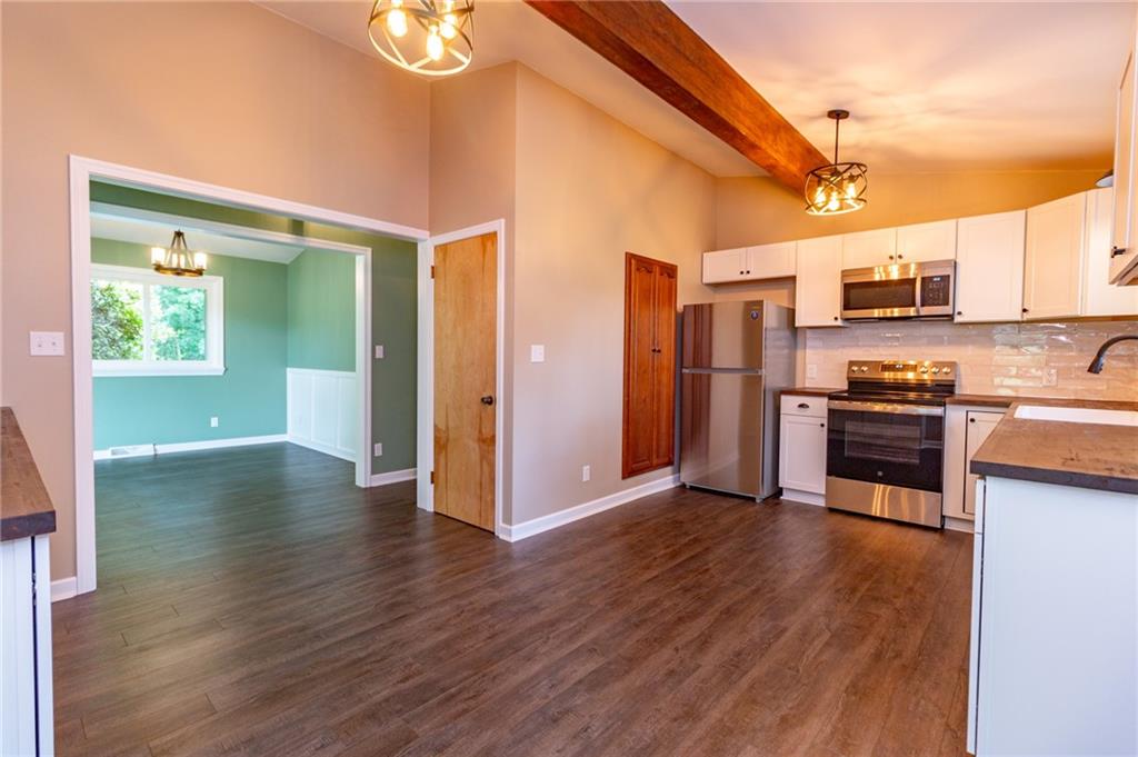 681 Bullcreek Road Butler, PA 16002 - Photo 12 of 39 a view of kitchen with stainless steel appliances wooden floor and chair