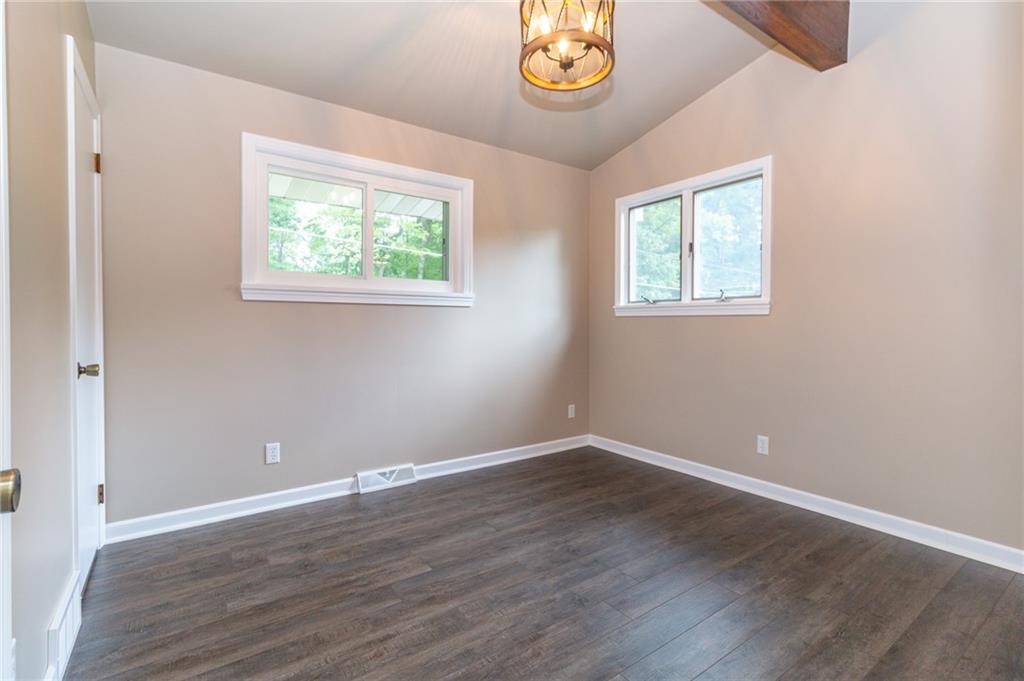 681 Bullcreek Road Butler, PA 16002 - Photo 17 of 39 a view of an empty room with wooden floor and a window
