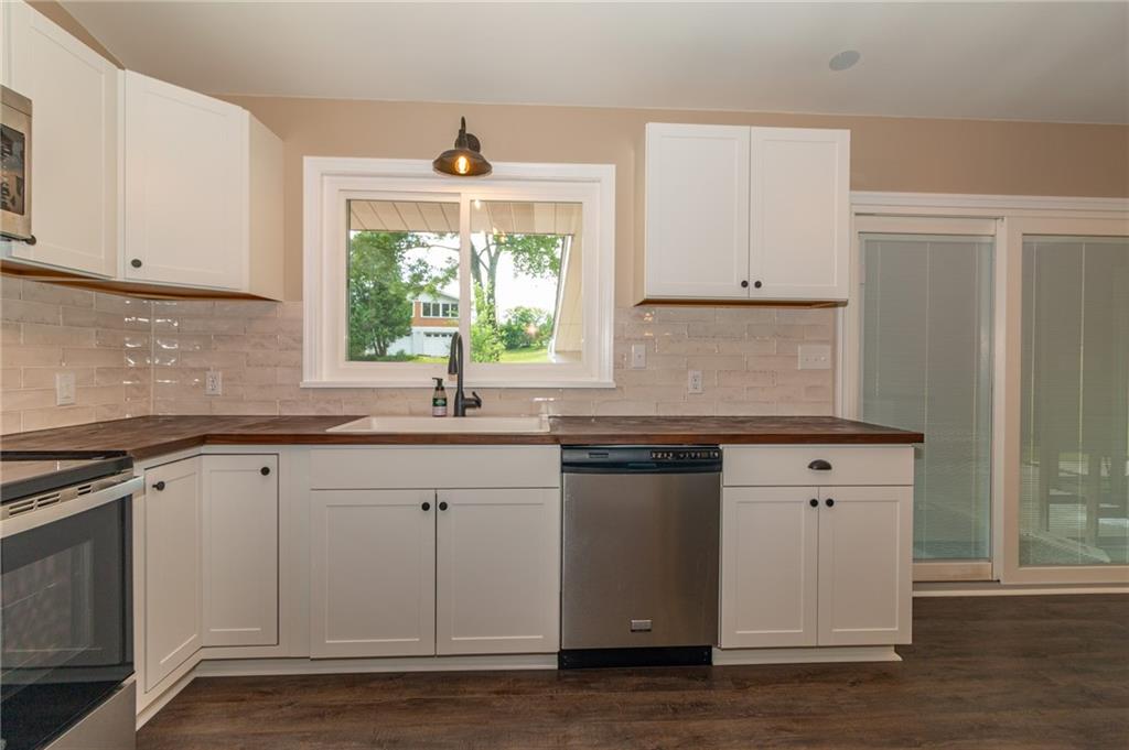 681 Bullcreek Road Butler, PA 16002 - Photo 8 of 39 a kitchen with granite countertop white cabinets white appliances with a sink and dishwasher