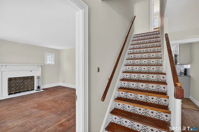 a view of entryway with stairs and wooden floor