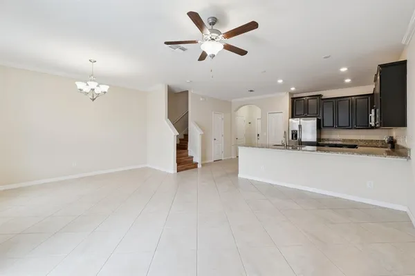 a view of a kitchen with a sink and a ceiling fan