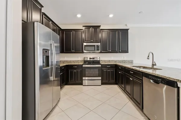 a kitchen with granite countertop stainless steel appliances and cabinets