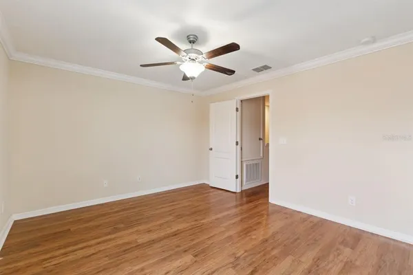 a view of an empty room with wooden floor