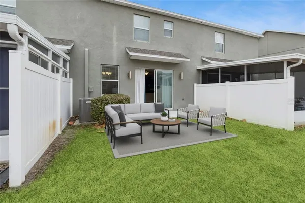 a view of a house with backyard sitting area and garden