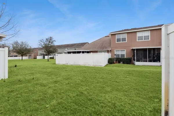 a view of house with backyard