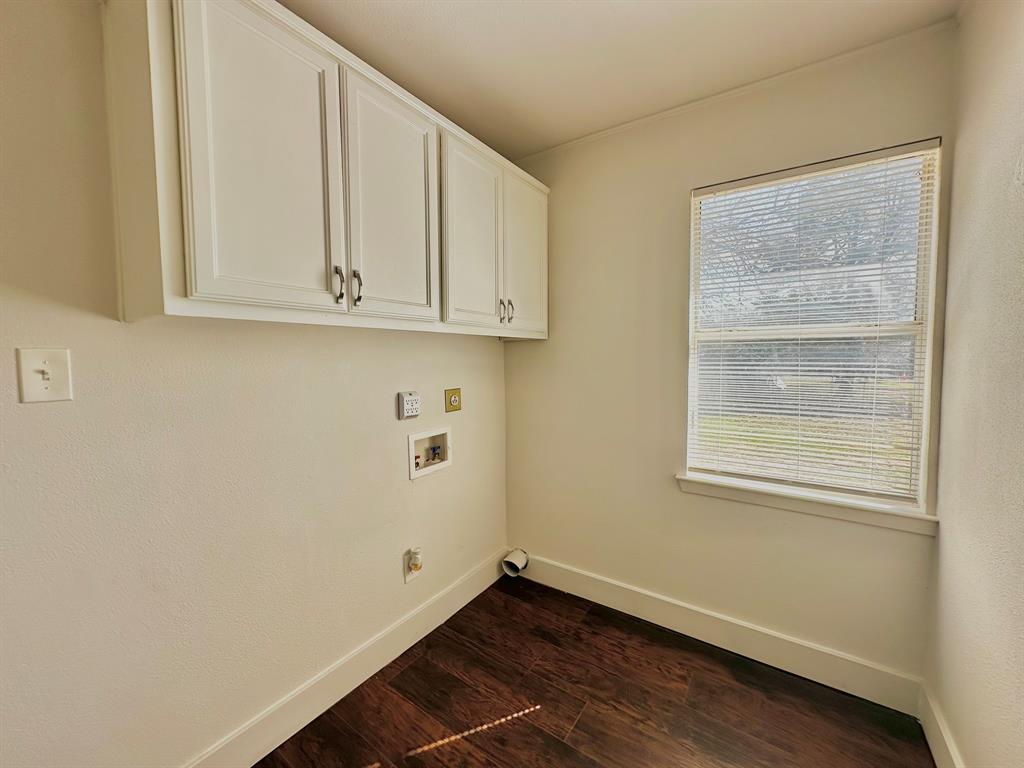 161 Elizabeth Street, Unit A Pottsboro, TX 75076 - Photo 12 of 20 a view of an empty room with wooden floor and a window