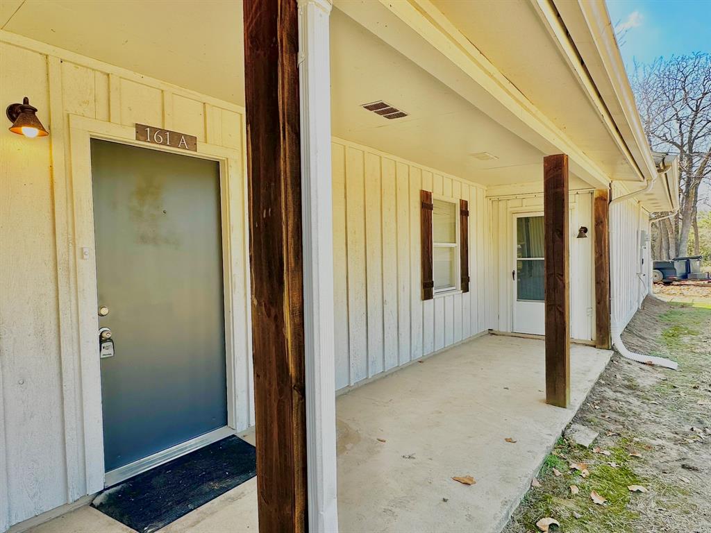 161 Elizabeth Street, Unit A Pottsboro, TX 75076 - Photo 13 of 20 a view of a hallway with wooden cabinets