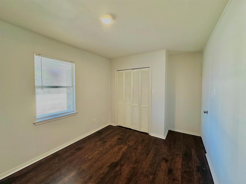 161 Elizabeth Street, Unit A Pottsboro, TX 75076 - Photo 14 of 20 a view of an empty room with wooden floor and a window