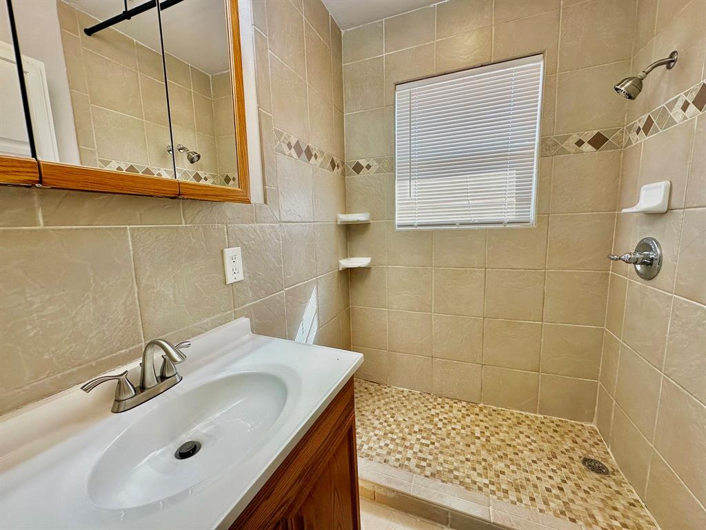 161 Elizabeth Street, Unit A Pottsboro, TX 75076 - Photo 15 of 20 a bathroom with a sink and a mirror