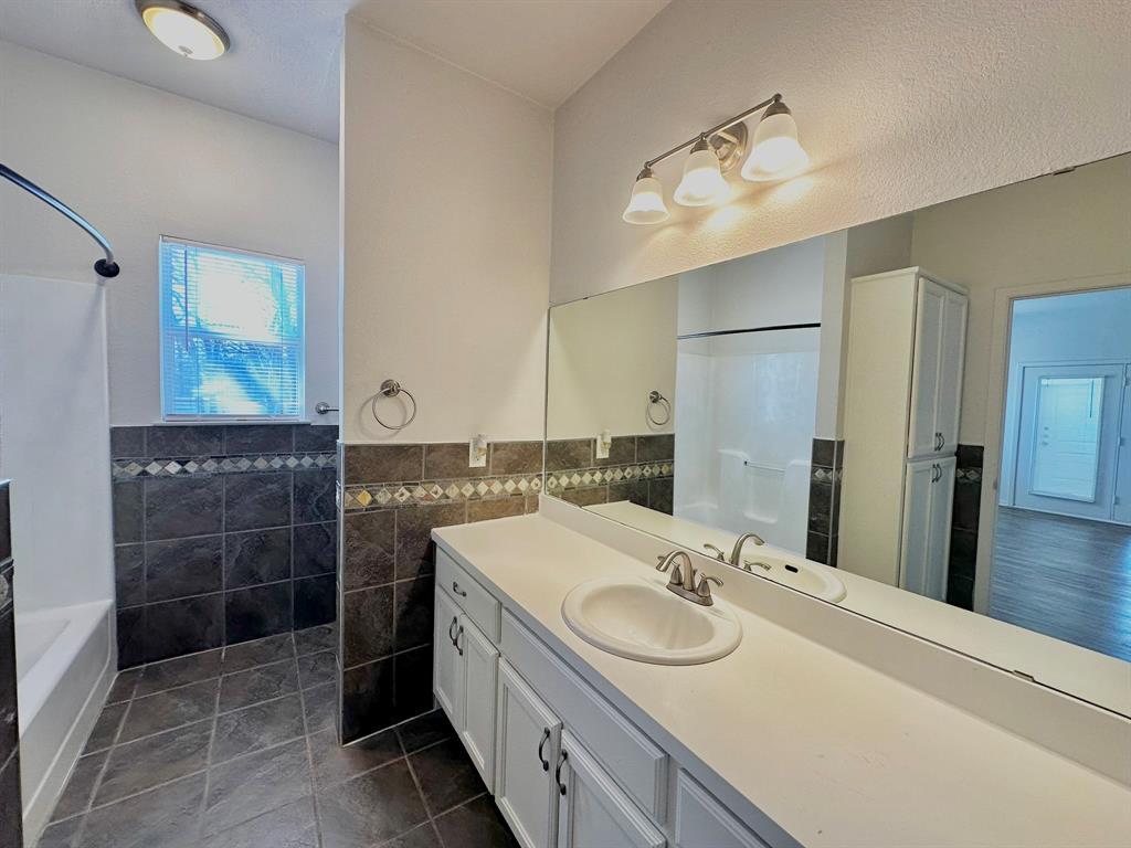 161 Elizabeth Street, Unit A Pottsboro, TX 75076 - Photo 4 of 20 a bathroom with a sink and a mirror