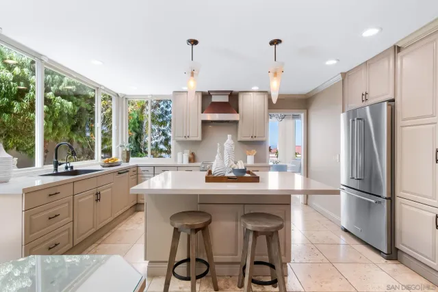 a kitchen with granite countertop a sink appliances a counter space and a window