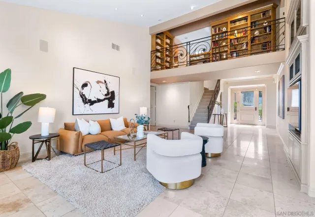 a living room with furniture and a painting on the wall