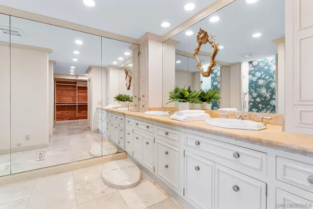 a bathroom with a double vanity sink and a mirror