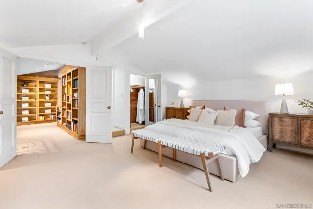 a spacious bedroom with a bed and walk in closet