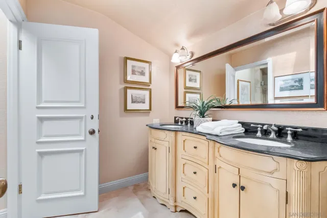 a bathroom with double sink and a mirror