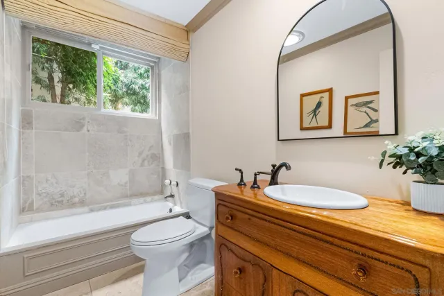 a bathroom with a sink a toilet and bathtub