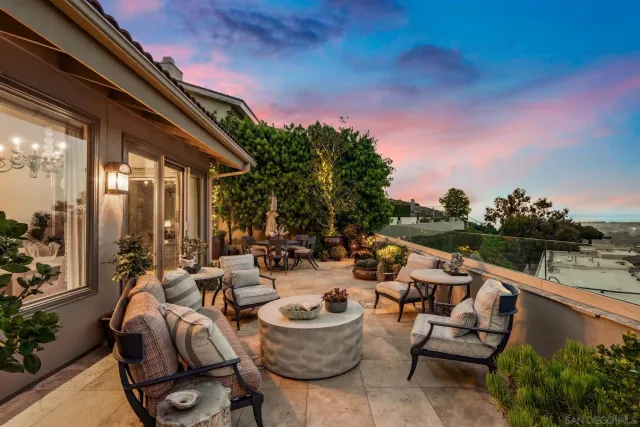 a view of balcony with furniture and a potted plant
