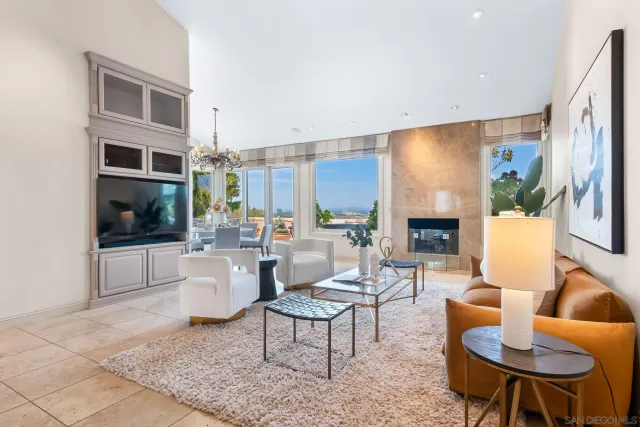 a living room with furniture a rug and a large window