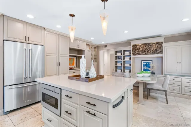 a kitchen with kitchen island a stove a refrigerator and a refrigerator