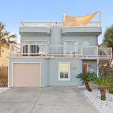 a view of a white building among the front of a house