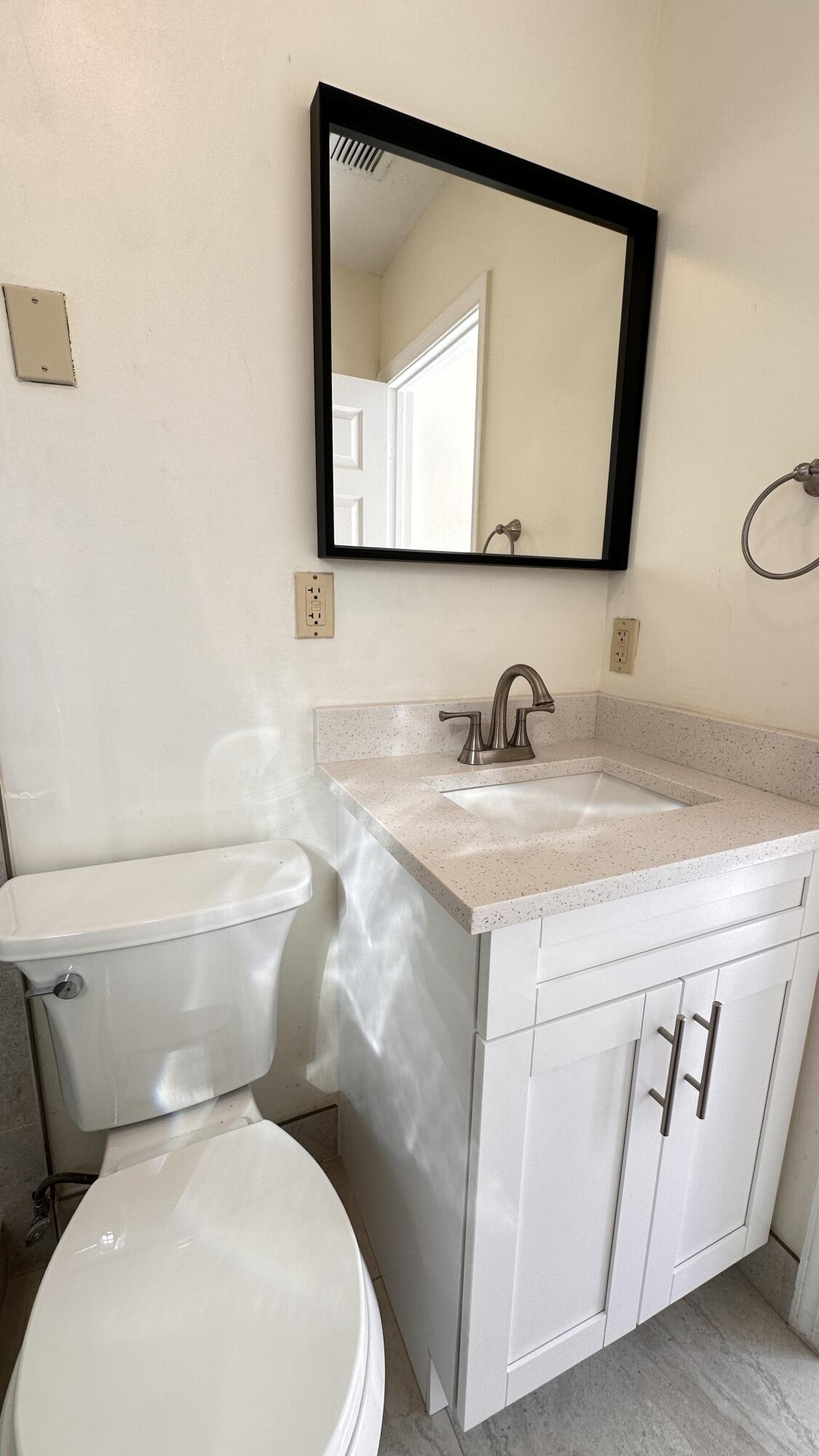19010 Southwest 10th Street Pembroke Pines, FL 33029 - Photo 16 of 59 a bathroom with a toilet sink and mirror