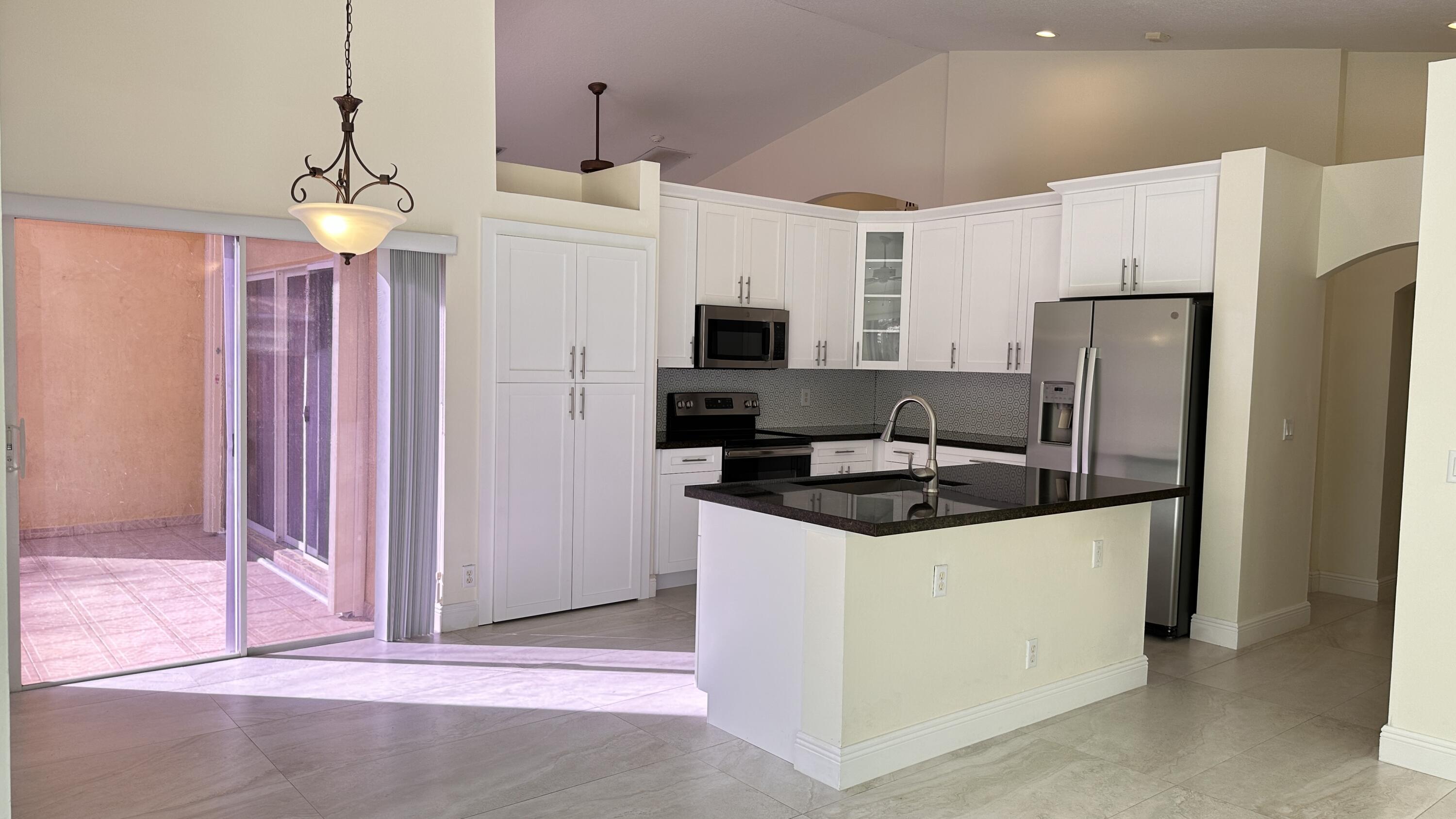 19010 Southwest 10th Street Pembroke Pines, FL 33029 - Photo 17 of 59 a kitchen with stainless steel appliances granite countertop a stove a refrigerator and a sink