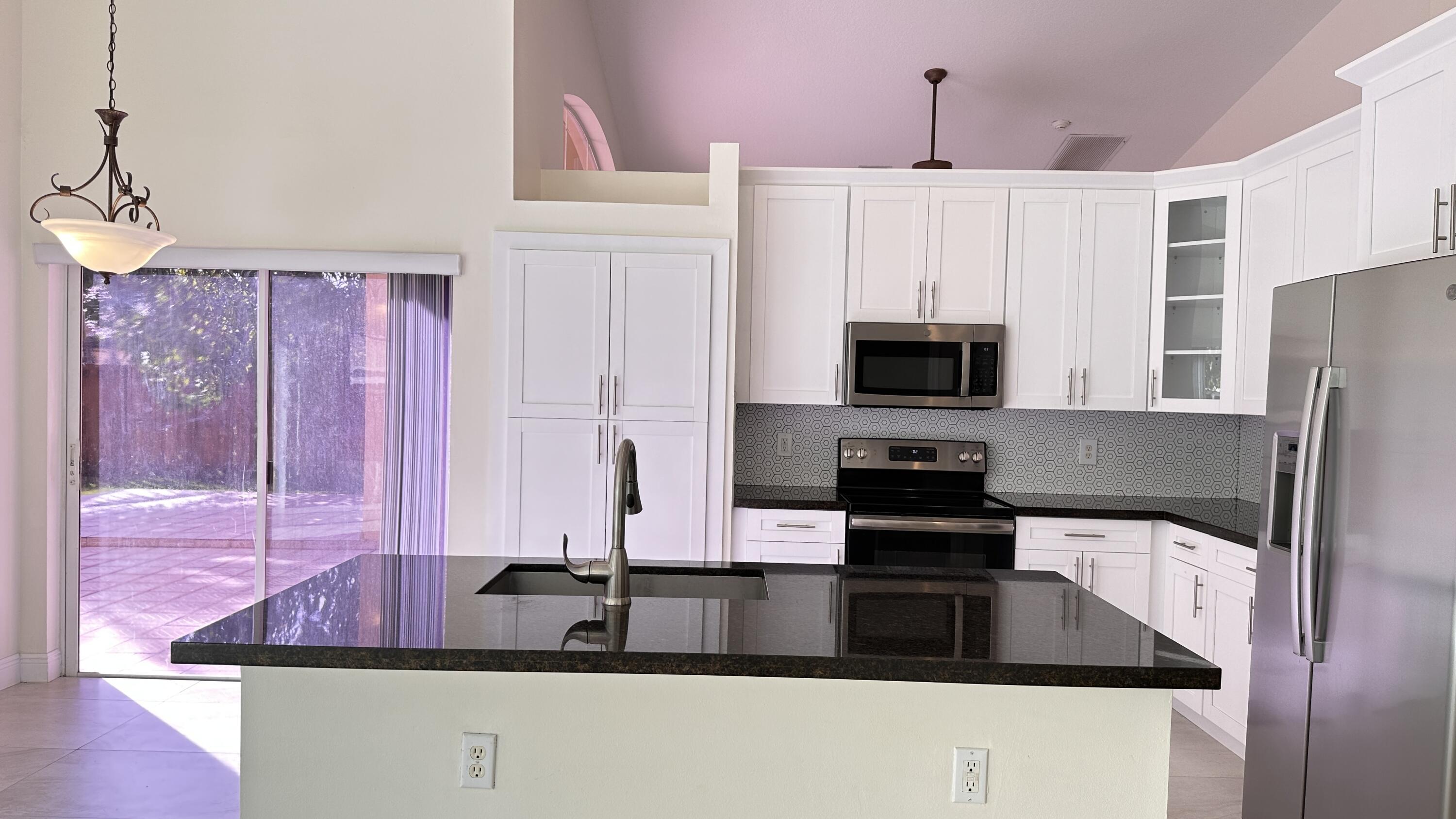 19010 Southwest 10th Street Pembroke Pines, FL 33029 - Photo 18 of 59 a kitchen with stainless steel appliances a stove refrigerator and microwave