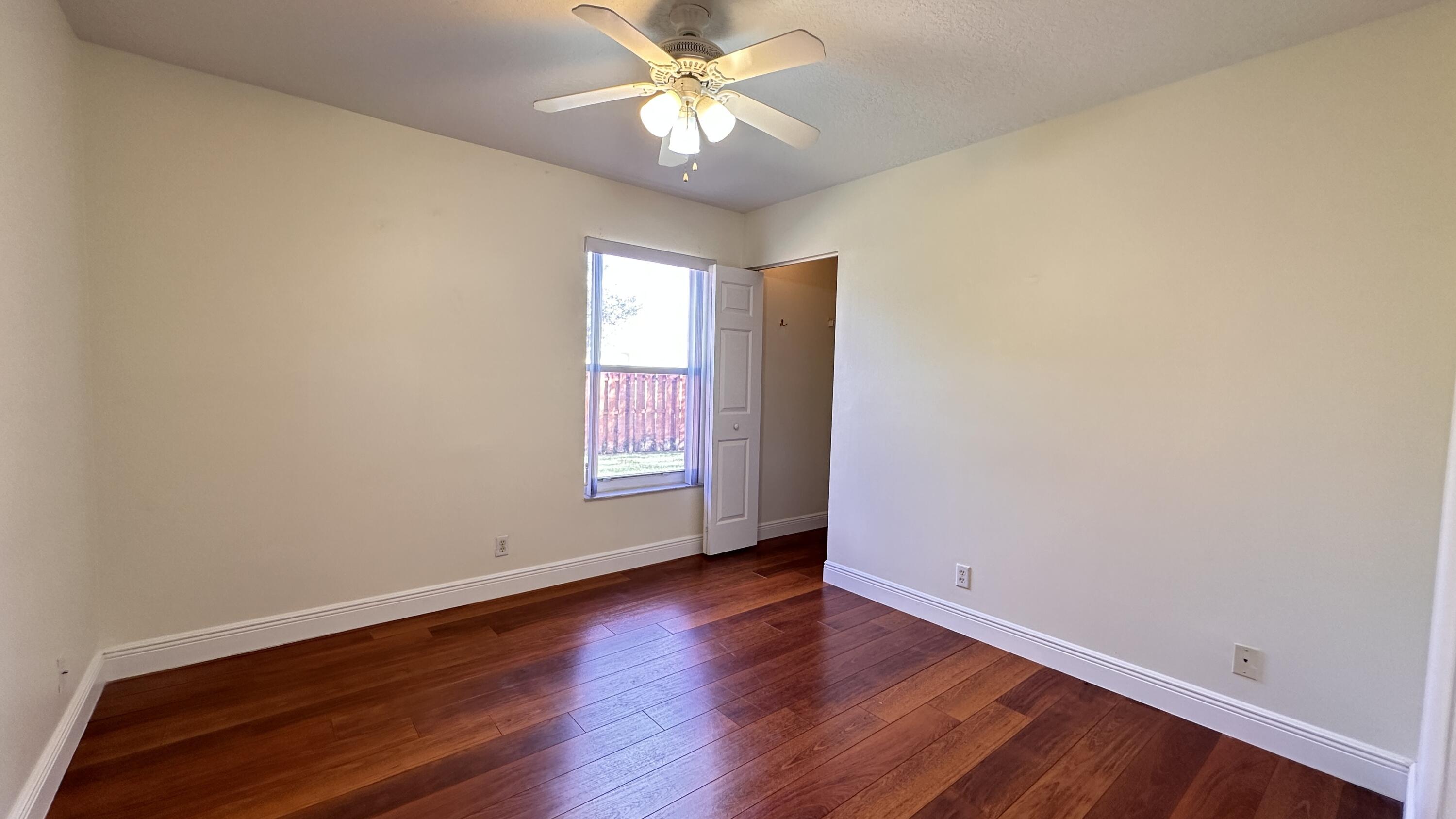19010 Southwest 10th Street Pembroke Pines, FL 33029 - Photo 23 of 59 an empty room with wooden floor and windows