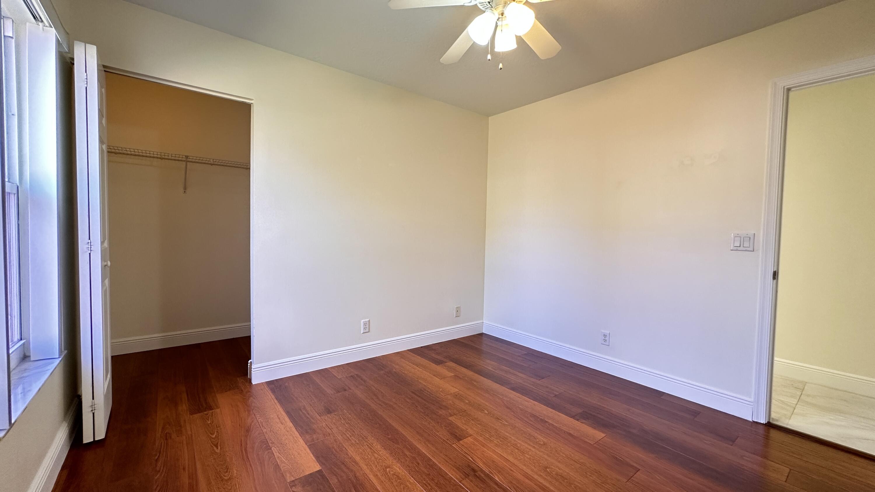 19010 Southwest 10th Street Pembroke Pines, FL 33029 - Photo 24 of 59 an empty room with wooden floor and chandelier