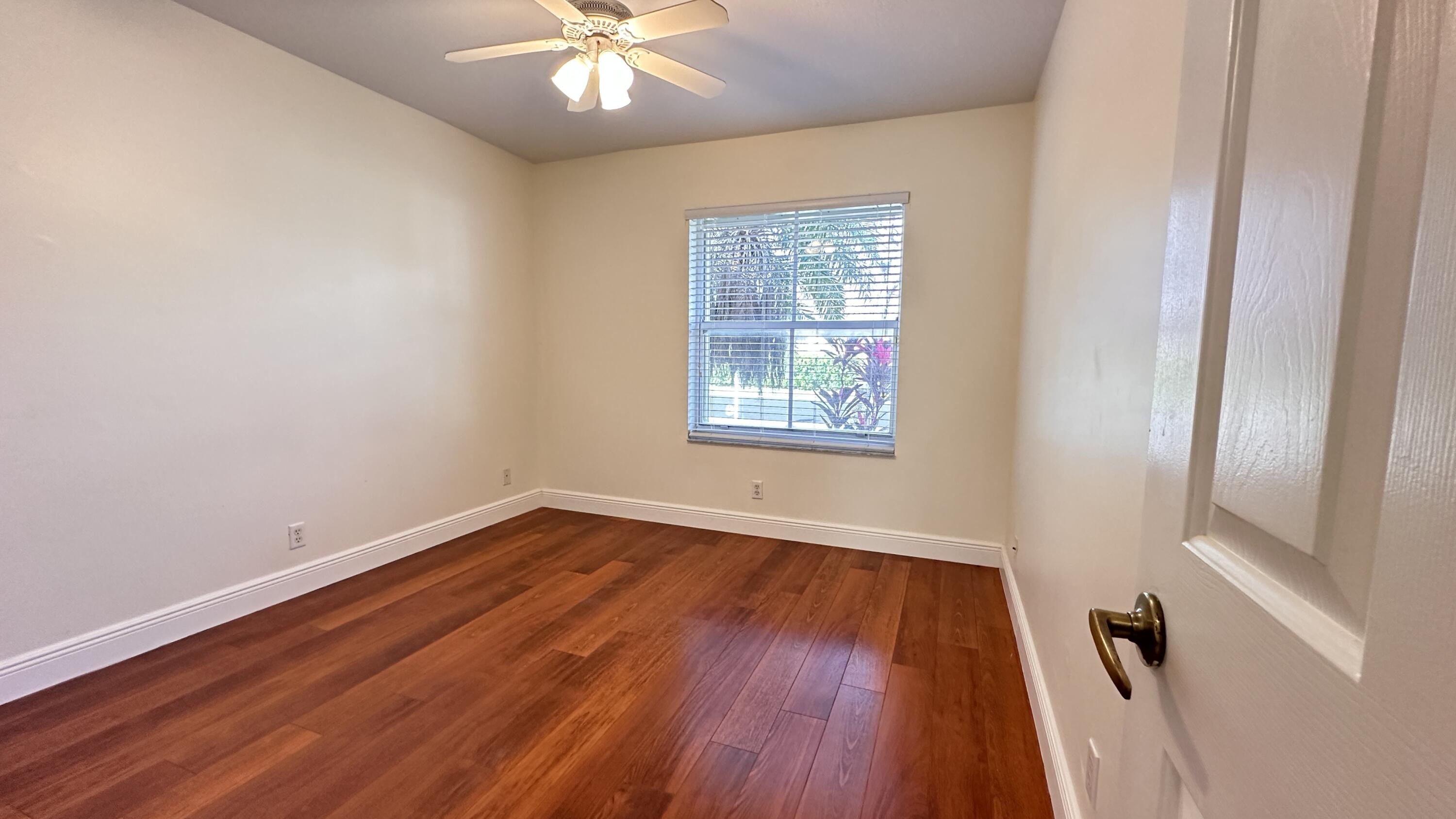 19010 Southwest 10th Street Pembroke Pines, FL 33029 - Photo 25 of 59 an empty room with wooden floor and windows