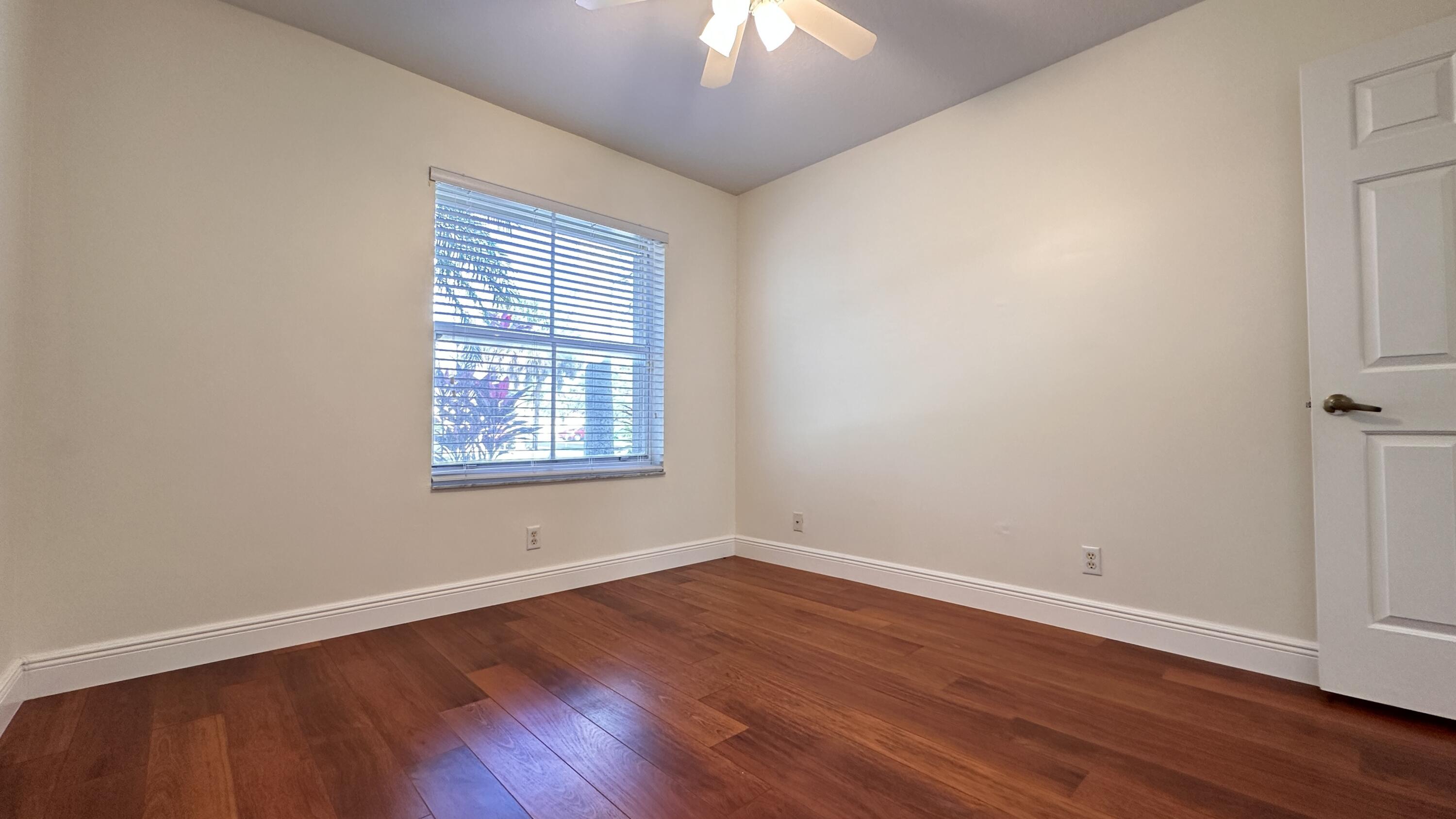 19010 Southwest 10th Street Pembroke Pines, FL 33029 - Photo 27 of 59 a view of an empty room with wooden floor and a window