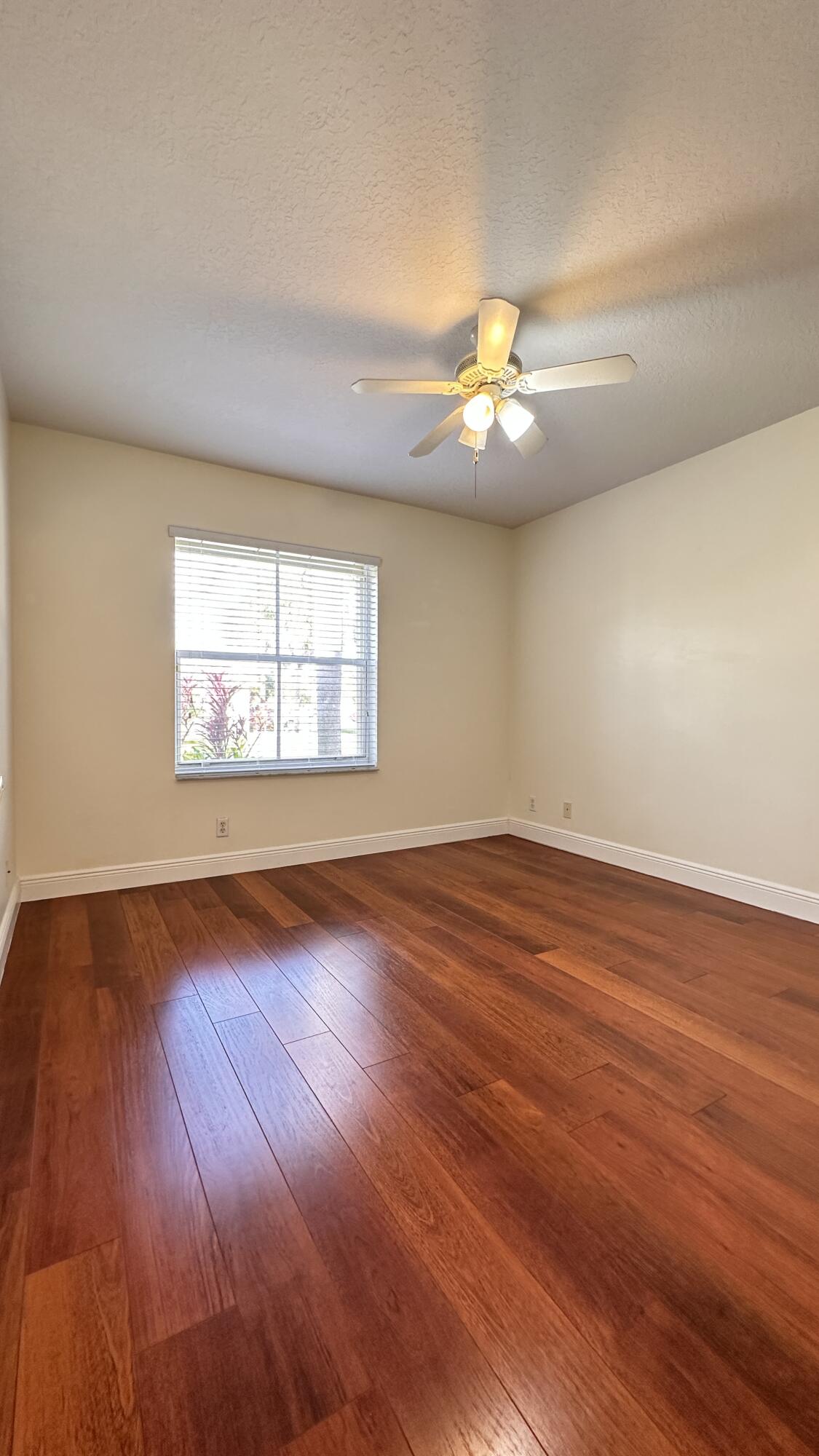19010 Southwest 10th Street Pembroke Pines, FL 33029 - Photo 30 of 59 an empty room with wooden floor chandelier fan and windows